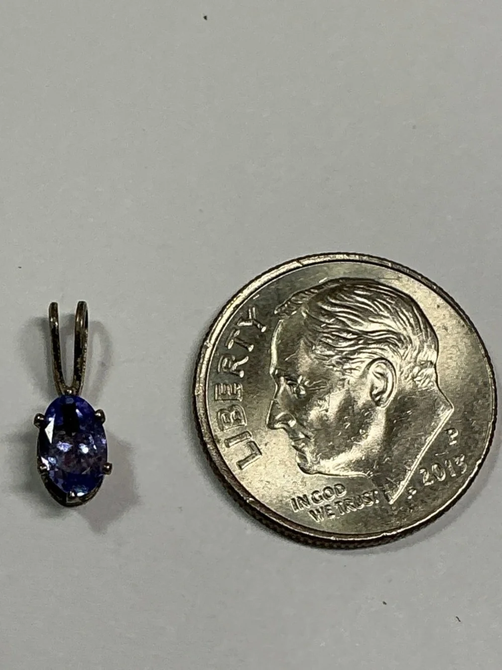 Sterling Silver Petite Blue Oval Shape Pendant. 1/2 inches long
